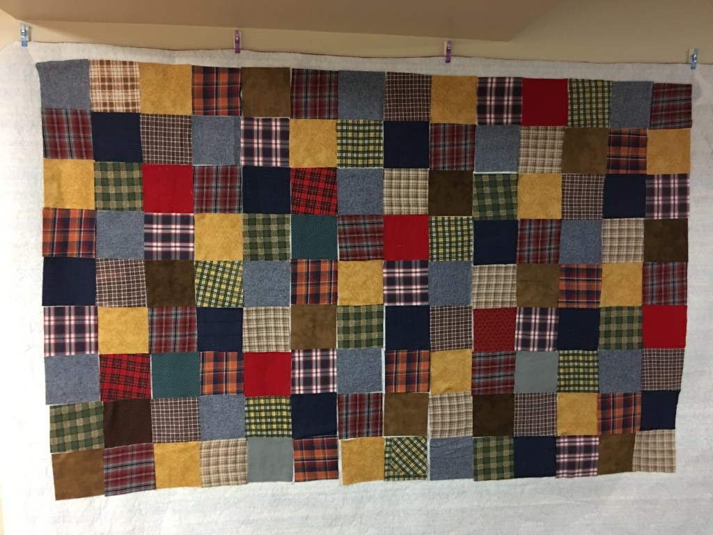 Laying out blocks for a memory quilt.